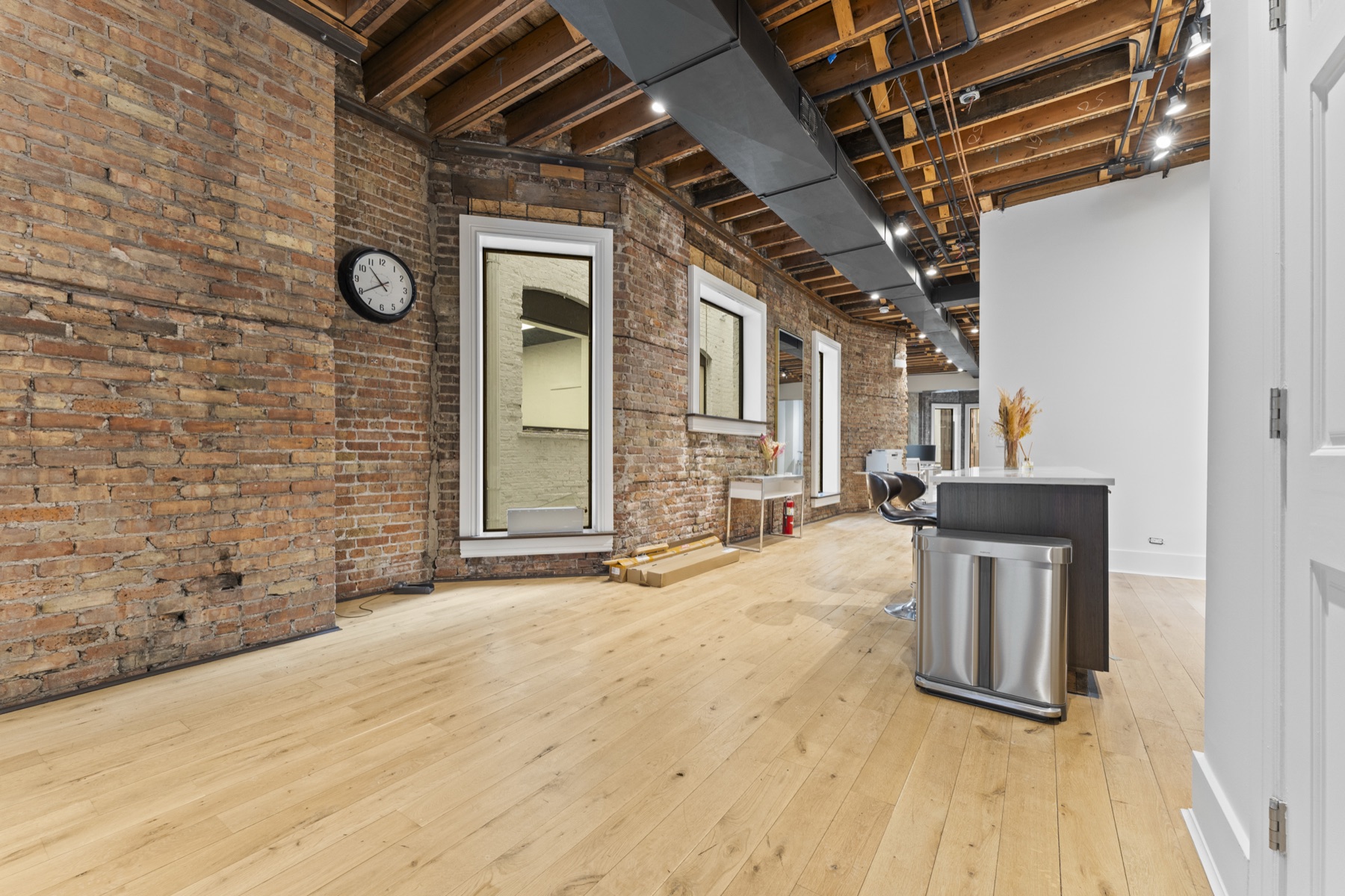 Original exposed brick and wood beams in the common floor area.