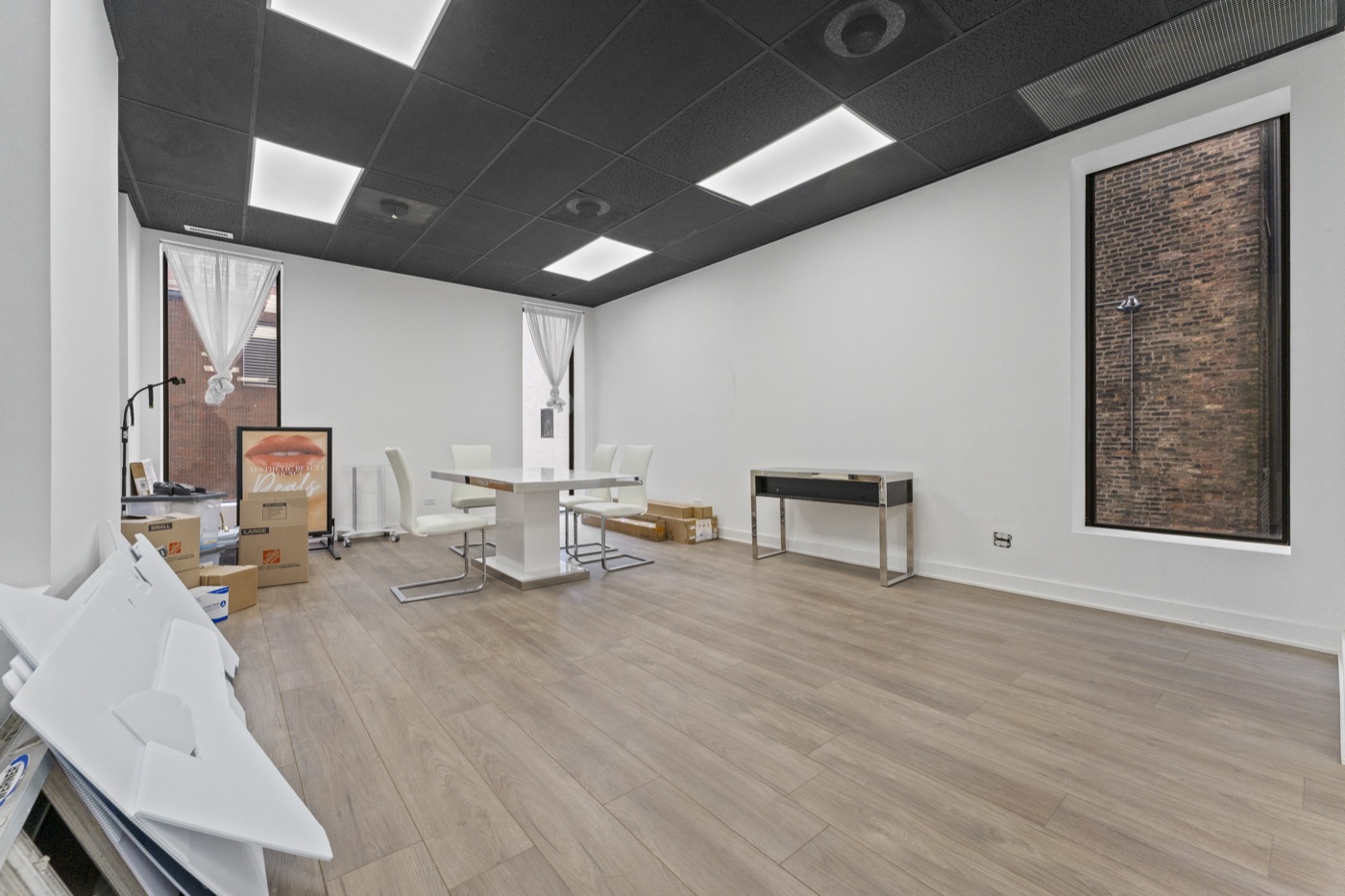 Suite D — bright studio suite with bay window, brick accent and clean modern finish.